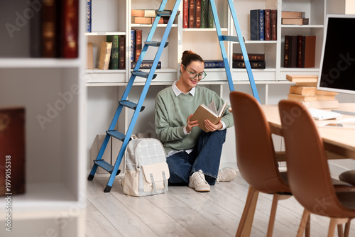 Young woman reading book un...