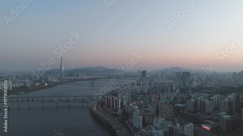 Aerial night view of the illuminated Seoul skyline and Han River from Gwangjin-gu, South Korea.