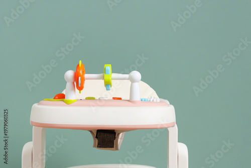 Baby walker on green backgr...