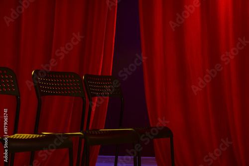 Empty seats near red curtains in audition room