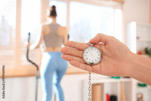 Female hand with stopwatch ...