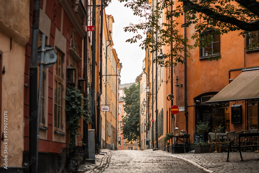 Fototapeta premium Gamla Stan old city in Stockholm, Sweden. Historic yellow and orange homes with narrow alleys.