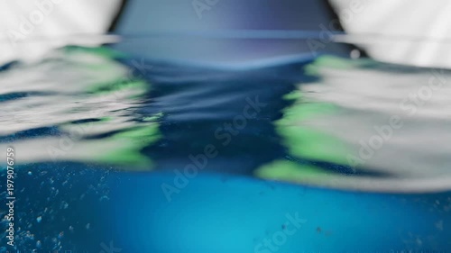 Close-up of blue liquid with gentle green reflections and ripples
