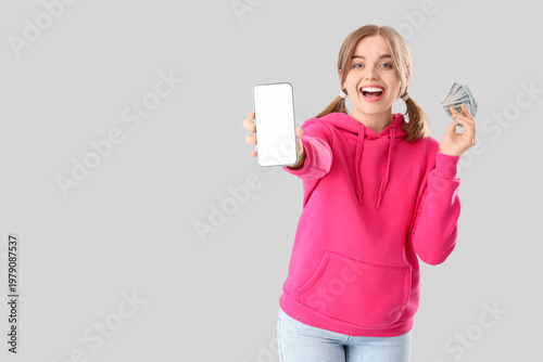 Happy young woman with mone...