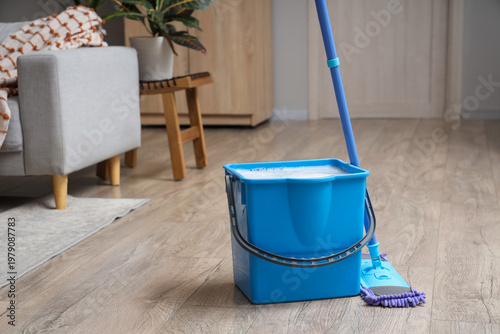 Mop with blue bucket of wat...