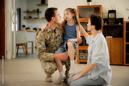 Photos Happy military father in uniform returning home hugging his young daughter while