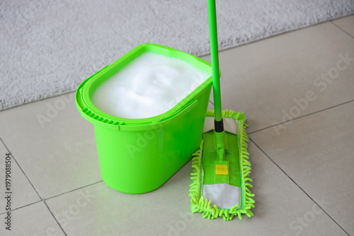 Mop with bucket of water in...