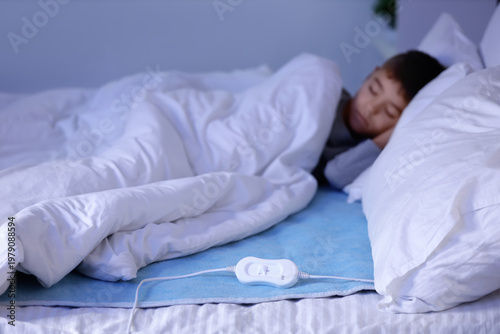 Little boy sleeping under b...