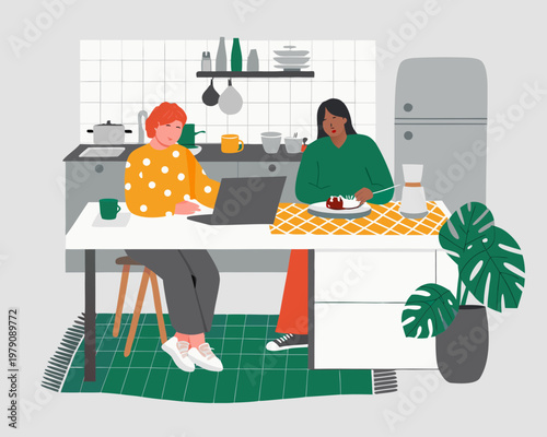 Two women share breakfast and work in a modern kitchen setting
