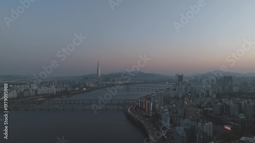 Aerial night view of the illuminated Seoul skyline and Han River from Gwangjin-gu, South Korea.