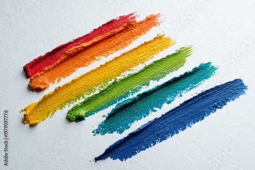 Diagonal rainbow-colored paint strokes on white paper, vibrant and textured