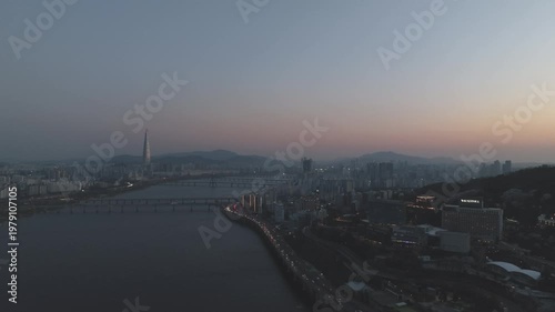Aerial night view of the illuminated Seoul skyline and Han River from Gwangjin-gu, South Korea.