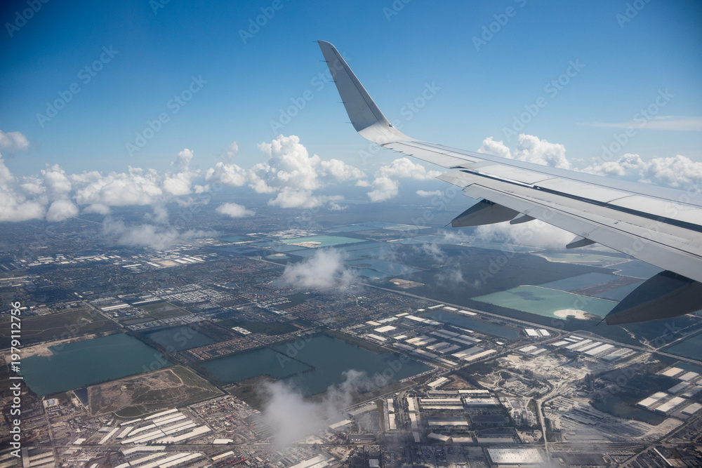 Fototapeta premium Aerial view of Miami industrial district with warehouses, lakes, roads and residential neighborhoods in Florida, USA. g.