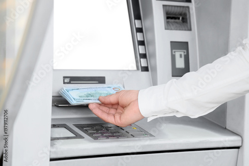 Male hand withdrawing money...