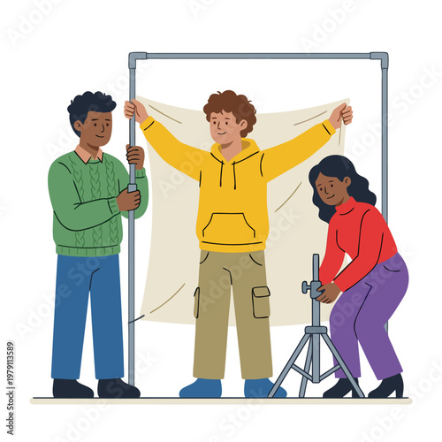 Three people setting up a photography studio backdrop.