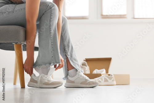 Young woman trying on new s...