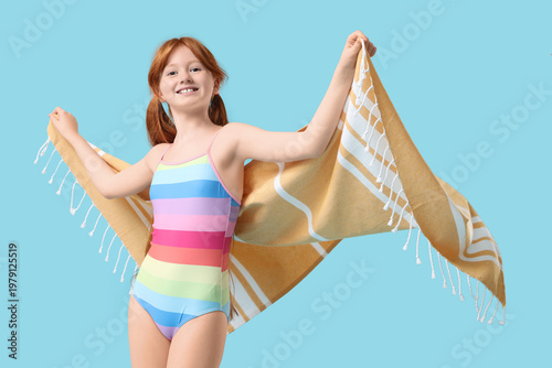 Little redhead girl in swim...