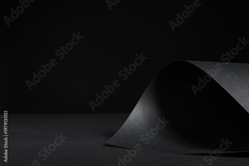 Black paper sheet on dark b...