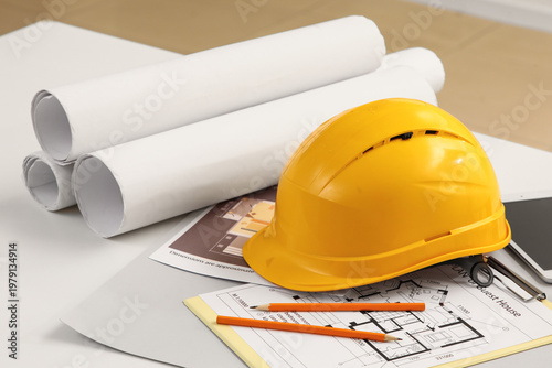 Hardhat with house plans on...