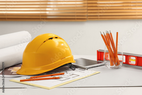 Hardhat with house plans on...
