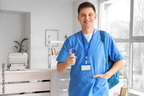 Male medical intern with ba...