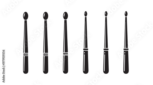 Drumsticks arranged in a row showing varied sizes and tip shapes on a white background