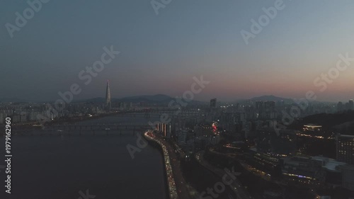 Aerial night view of the illuminated Seoul skyline and Han River from Gwangjin-gu, South Korea.