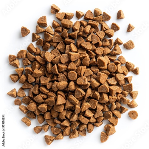 Overhead view of a pile of small, brown, triangular-shaped dog food kibble on a white background.