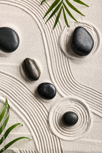 Black stones and palm leave...