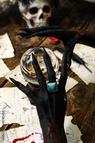 Bloody black witch hands wi...