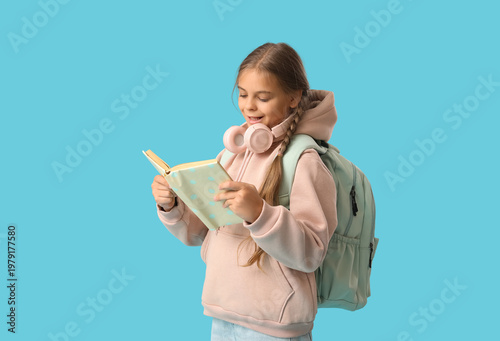 Cute schoolgirl reading boo...