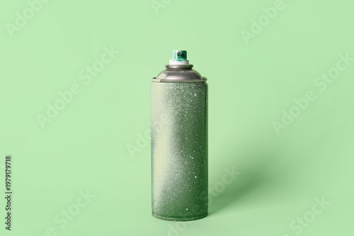 Spray paint can on green ba...
