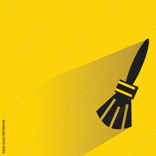 paint brush icon with shadow on yellow background