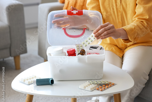 Woman putting pills in firs...