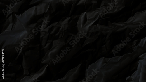 Crumpled black paper texture background with wrinkled folds and creases abstract dark design element