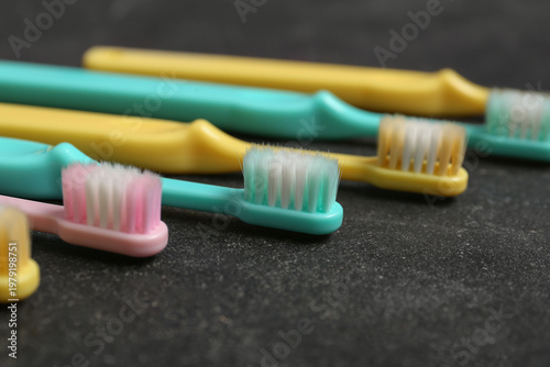 Colorful toothbrushes on bl...