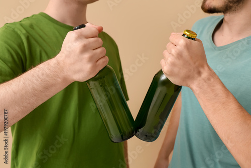 Men with bottles of beer on...