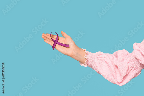 Female hand with purple rib...