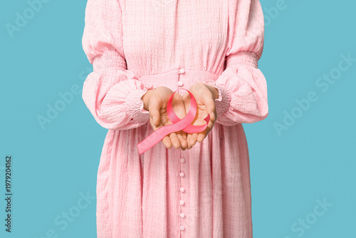 Woman holding pink ribbon o...