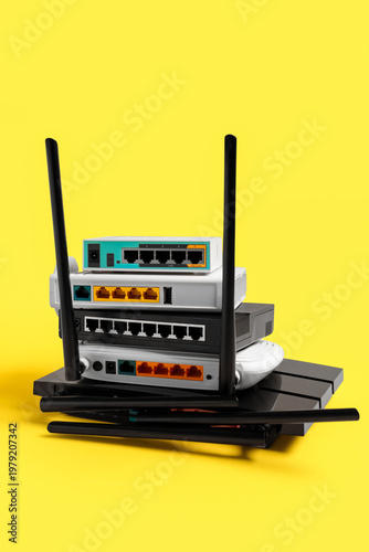 Modern wi-fi routers on yel...