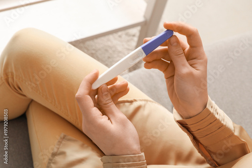 Woman with pregnancy test a...