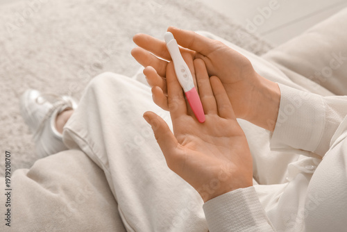 Woman with pregnancy test s...