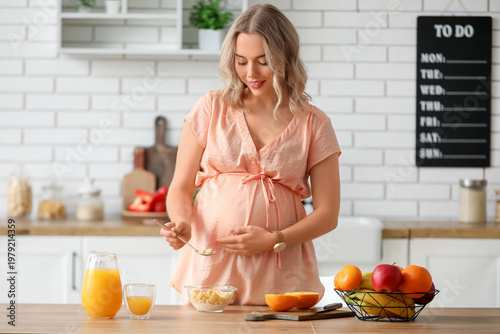 Young pregnant woman eating...