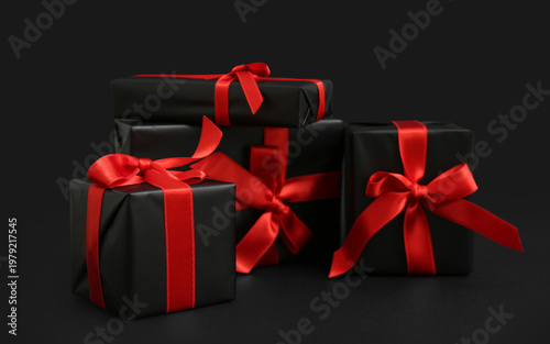 Many gift boxes on dark bac...