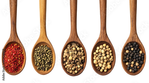 Various spices in wooden spoons: red pepper powder, white peppercorns, pink peppercorns, black peppercorns, and green peppercorns.