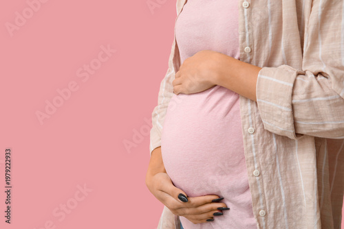 Pregnant woman on pink back...