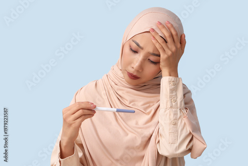 Sad Muslim woman with pregn...
