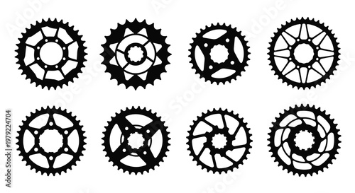 Collection of bicycle chainrings displayed in a stark black silhouette