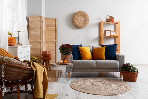 Interior of living room with sofa and pumpkins