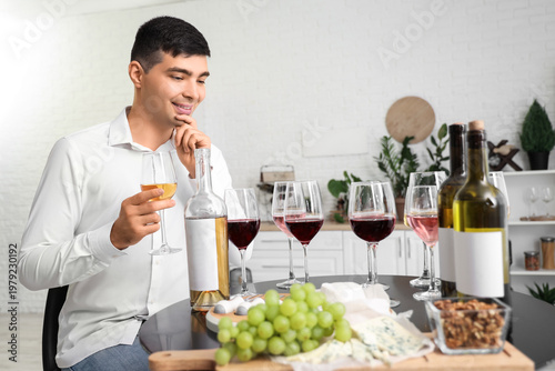 Thoughtful young sommelier ...